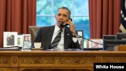 President Barack Obama talks with President Hassan Rouhani of Iran during a phone call in the Oval Office, Sept. 27, 2013.