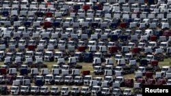 FILE - New Ford trucks are seen at a parking lot of the Ford factory in Sao Bernardo do Campo, Brazil, Feb. 12, 2015. 