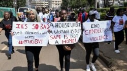 FILE - Protesters carry banners and chant slogans as they march through Eldoret, western Kenya, , to demonstrate against the murder of women in Kenya, on Sept. 13, 2024.