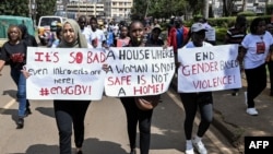 FILE - Protesters carry banners and chant slogans as they march through Eldoret, western Kenya, , to demonstrate against the murder of women in Kenya, on Sept. 13, 2024.