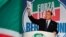 Former Italian Prime Minister Silvio Berlusconi holds a campaign booklet as he addresses a rally of right-wing Forza Italia party, March 30, 2019, at the Congress Center in Rome, ahead of the May 2019 European elections. 