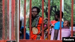 FILE - Relatives of followers of the Good News International Church, who believed they would go to heaven if they starved themselves to death in Shakahola, stand outside the steel gate of the Malindi sub district hospital mortuary in Malindi, Kilifi county, Kenya April 27, 2023.