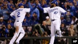 Kansas City Royals pitcher Johnny Cueto (47) celebrates with Alcides Escobar after a ground ended the seventh inning of Game 2 of the Major League Baseball World Series against the New York Mets, October 28, 2015, in Kansas City, Mo.