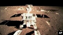 FILE - This image taken from video, shows China's first moon rover touching the lunar surface on Dec. 15, 2013.
