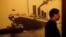 FILE - A visitor walks past a big portrait of the Titanic at the Titanic Experience and Priceless Artifact Exhibition in Shanghai, Aug. 11, 2004. 