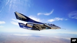 FILE - In this May 29, 2018 photo provided by Virgin Galactic, the VSS Unity craft flies during a supersonic flight test.