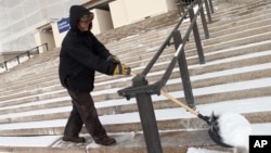 Paul Linquist braves subzero temperatures to shovel snow from the steps of the Minnesota State Capitol in St. Paul in preparation for the start of the 2015 legislative session, Jan. 6, 2015.