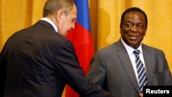 Zimbabwean President Emmerson Mnangagwa greets Russian Foreign Minister Sergey Lavrov before their meeting in Harare, Zimbabwe, March 8, 2018. 