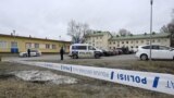 Finnish police officers guard the scene behind police tapes at the primary Viertola comprehensive school where a child opened fire and injured three other children, on April 2, 2024 in Vantaa, outside the Finnish capital Helsinki.
