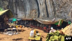 This picture taken on June 1, 2021 shows people taking refuge in a jungle area in Demoso, Kayah state, after they fled from conflict zones where fighting between the Myanmar military and members of the People's Defence Force (PDF) took place as the countr