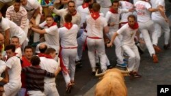 Revellers run in front of Cebada Gago fighting bulls during the first running of the bulls at the San Fermin Festival, in Pamplona, northern Spain, July 7, 2017.