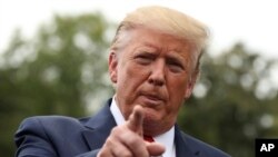 President Donald Trump speaks to members of the media on the South Lawn of the White House in Washington, Sept. 9, 2019, before boarding Marine One for a short trip to Andrews Air Force Base, Md., and then on to North Carolina. 