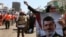 Egyptian supporters of Muslim Brotherhood and Egypt's ousted president Mohamed Morsi [pictured on poster] take part in a self-defense training outside Rabaa al-Adawiya mosque in Cairo, July 16, 2013.