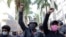 People protest against crimes committed by the police against black people in the favelas, outside the Rio de Janeiro's state government, Brazil, Sunday, May 31, 2020.