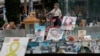 A woman looks at pictures of hostages kidnapped during the deadly October 7 attack on Israel by Hamas, one year since the deadly Oct. 7, 2023 attack, in Tel Aviv, Oct. 7, 2024. 