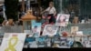 A woman looks at pictures of hostages kidnapped during the deadly October 7 attack on Israel by Hamas, one year since the deadly Oct. 7, 2023 attack, in Tel Aviv, Oct. 7, 2024. 