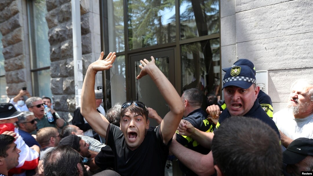 Protesters storm the office of LGBT+ campaigners at a rally against the planned March for Dignity during Pride Week in Tbilisi, Georgia, July 5, 2021. 