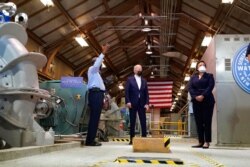 President Joe Biden tours a pumping room at the Sewerage &amp; Water Board's Carrollton water plant, May 6, 2021, in New Orleans, as New Orleans Mayor LaToya Cantrell listens at right.