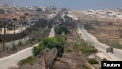 A Palestinian man drives on the border between Egypt and the southern Gaza Strip, Sept. 3, 2013. 