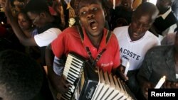 A man plays an accordion during a prayer session following an attack by gunmen at the Garissa University College campus, along the streets of the capital Nairobi, April 7, 2015. The Kenyan air force has destroyed two al Shabaab camps in Somalia, it said o