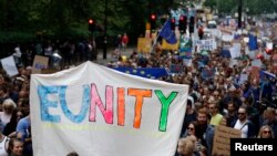 People hold banners during a "March for Europe" demonstration against Britain's decision to leave the European Union, in central London, Britain, July 2, 2016. Britain voted to leave the European Union in the EU Brexit referendum. 