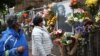 Mourners pay their respects to the late Archishop Desmond Tutu outside St. Georges cathedral in Cape Town, South Africa, Dec. 27, 2021.