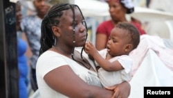 (FILE) Haitians fleeing gang violence find shelter in a sport arena, in Port-au-Prince. 