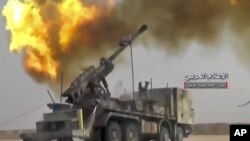 A picture taken from video provided Nov 8, 2017 by the government-controlled Syrian Central Military Media shows shelling on militants' positions on the Iraq-Syria border. 
