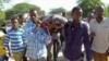 Mourners carry the body of Somali journalist Mohamed Mohamud who was killed after being shot six times by gunmen, Oct. 27, 2013. 