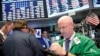 FILE - Traders work on the floor of the New York Stock Exchange (NYSE) in New York City.