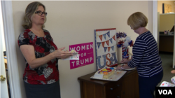 Trump campaign volunteers Linda Trocine and Hillary Courson shares cake to celebrate the president's birthday. (VOA video grab)