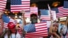 Attendees holds up American flag placards during the second day of the Republican National Committee midterm convention at the American Airlines Center in Dallas, Texas on September 10, 2026.