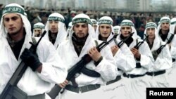 FILE - A Muslim brigade of the Bosnian Army marches in a military parade in Zenica in this 1995 photo. Muslim fighters from Afghanistan, North Africa and the Middle East joined the fighting in Bosnia in the early 1990s.