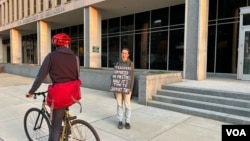 Joven estudiante de 23 años porta un letrero en el que se lee "Los maestros me apoyaron por 17 años, ahora es tiempo de apoyarlos a ellos" en respaldo a los profesores en la puerta del Departamento de Educación en Washington, D.C., el miércoles 12 de marzo de 2025.