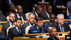 Delegates from the Ukraine listens as U.S.President Donald Trump addresses the 74th session of the United Nations General Assembly at U.N. headquarters, Sept. 24, 2019. 