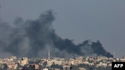 A picture taken from Rafah shows smoke billowing over Khan Yunis in the southern Gaza Strip following Israeli bombardment on December 15, 2023, amid continuing battles between Israel and the Palestinian militant group Hamas.