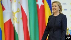 US Secretary of State Hillary Clinton walks in to shake hands with Kazakh President Nursultan Nazarbayev in Astana on December 1, 2010 during a welcoming ceremony of the OSCE Summit.