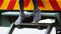 A man arrested for protesting over human rights abuses makes a court appearance in leg irons in Harare, Zimbabwe, Sept, 14, 2020.