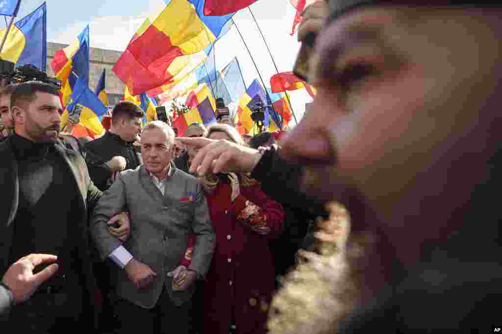 Calin Georgescu, the winner of Romania&#39;s first round presidential election, which the Constitutional Court later annulled, is surrounded by supporters during an event marking&nbsp; the anniversary of the 1859 unification of two provinces, a first step in the creation of the Romanian state, in Bucharest, Romania.