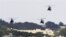 FILE - US military helicopters flying over the US Marine Corps Futenma Air Base in Ginowan, Okinawa Prefecture, Japan.
