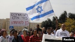 African migrants and Israeli activists demonstrate in support of the new agreement with the U.N. refugee agency to relocate thousands of African migrants, outside Israeli Prime Minister office in Jerusalem, April 3, 2018. 