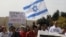 African migrants and Israeli activists demonstrate in support of the new agreement with the U.N. refugee agency to relocate thousands of African migrants, outside Israeli Prime Minister office in Jerusalem, April 3, 2018. 