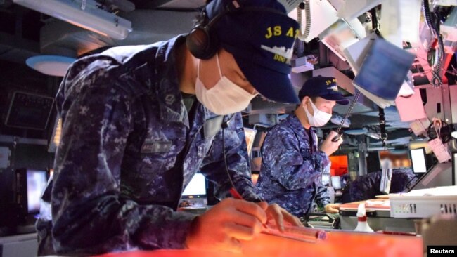 Japan Maritime Self Defense Force's members take part in a trilateral naval exercise with the U.S. Navy and South Korean Navy in this handout picture taken by the Japan Self-Defense Force and released Feb. 22, 2023. 