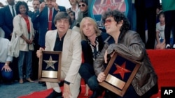 FILE - Rocker Tom Petty poses with the Everly Brothers, who got a star on the Hollywood Walk of Fame, Oct. 2, 1986. From left: Phil Everly, Petty, and Don Everly.