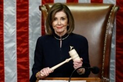 FILE - House Speaker Nancy Pelosi of Calif., smiles as she holds the gavel as the House votes on articles of impeachment against President Donald Trump by the House of Representatives at the Capitol in Washington, Dec. 18, 2019.