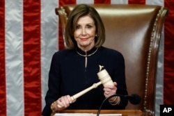 House Speaker Nancy Pelosi of Calif., smiles as she holds the gavel as the House votes on articles of impeachment against President Donald Trump by the House of Representatives at the Capitol in Washington, Dec. 18, 2019.