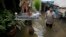 FILE - A Thai resident wades through a flooded area in Bangkok, Thailand, Oct. 3, 2011. Floods account for most of all disaster-related funding.