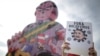 A demonstrator holds a banner reading, "Bolsonaro virus out," during a protest against the president in Brasilia on May 29, 2021.