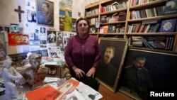 Nazi Stefanishvili, a 73-year-old retired economist, poses for a portrait in a room dedicated to Stalin at her home in Gori, Georgia, Dec. 6, 2016. 