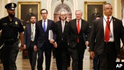 Treasury Secretary Steven Mnuchin, left, accompanied by White House Legislative Affairs Director Eric Ueland and acting White House chief of staff Mark Meadows, walks to the offices of Senate Majority Leader Mitch McConnell of Ky. on Capitol Hill.